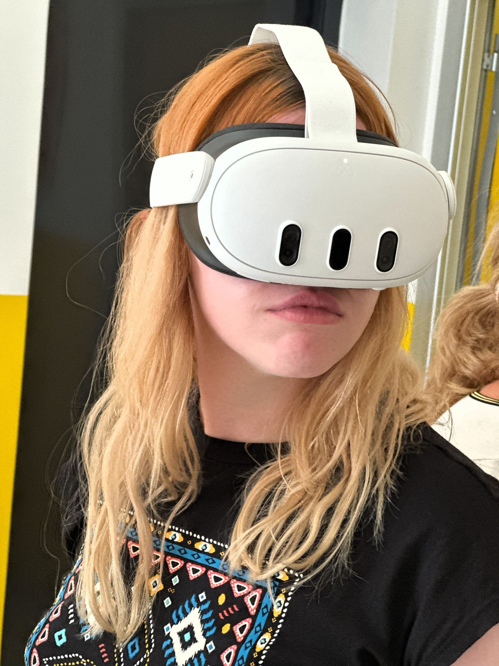 A teacher wearing a Meta Quest 3 headset